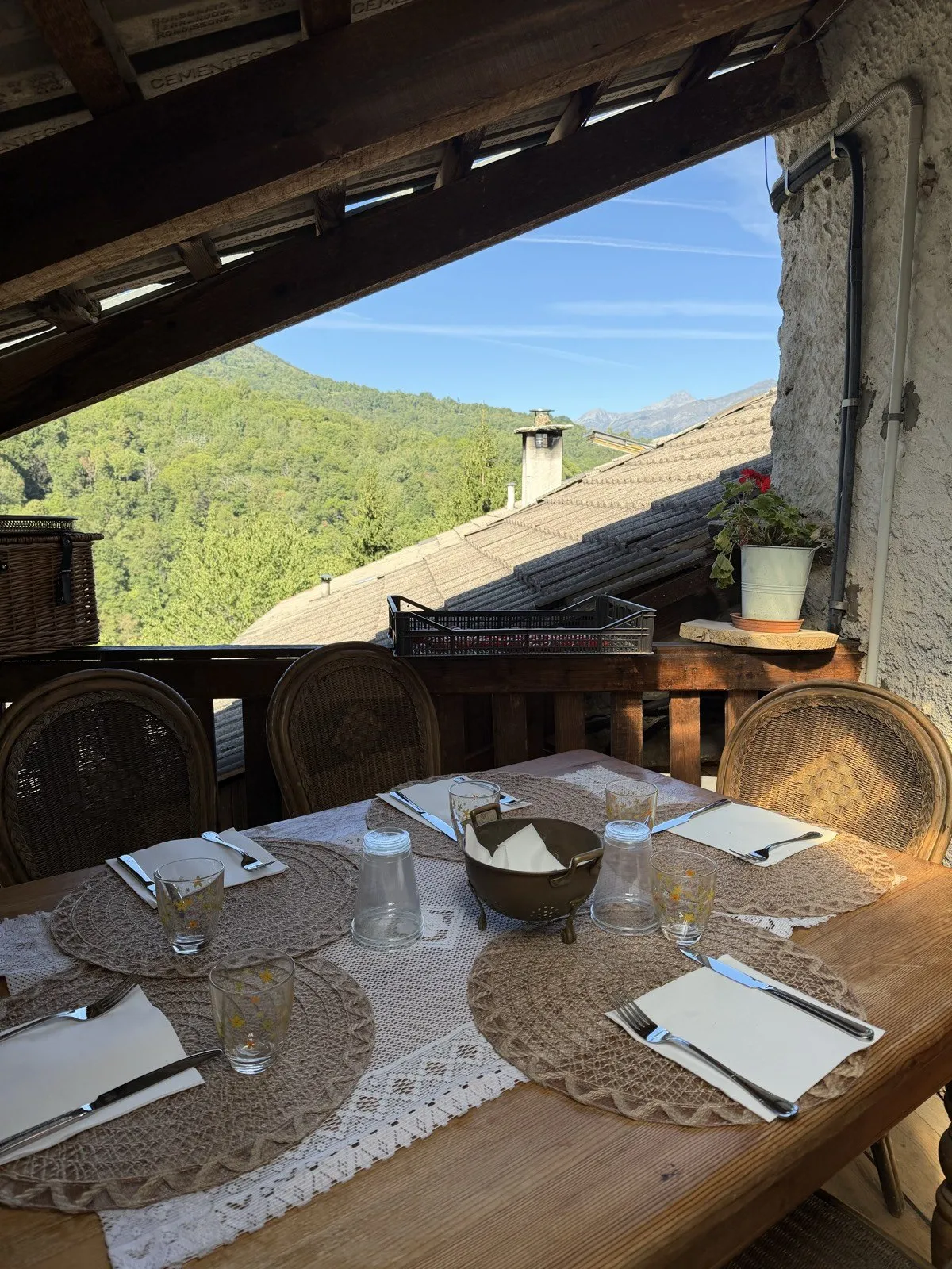 The table laid on the terrace at Borgata Biule, looking over the Valle Varaita woods