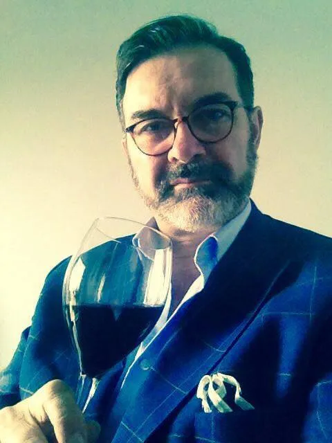 Aldo Steccanella with a glass of Piedmontese red